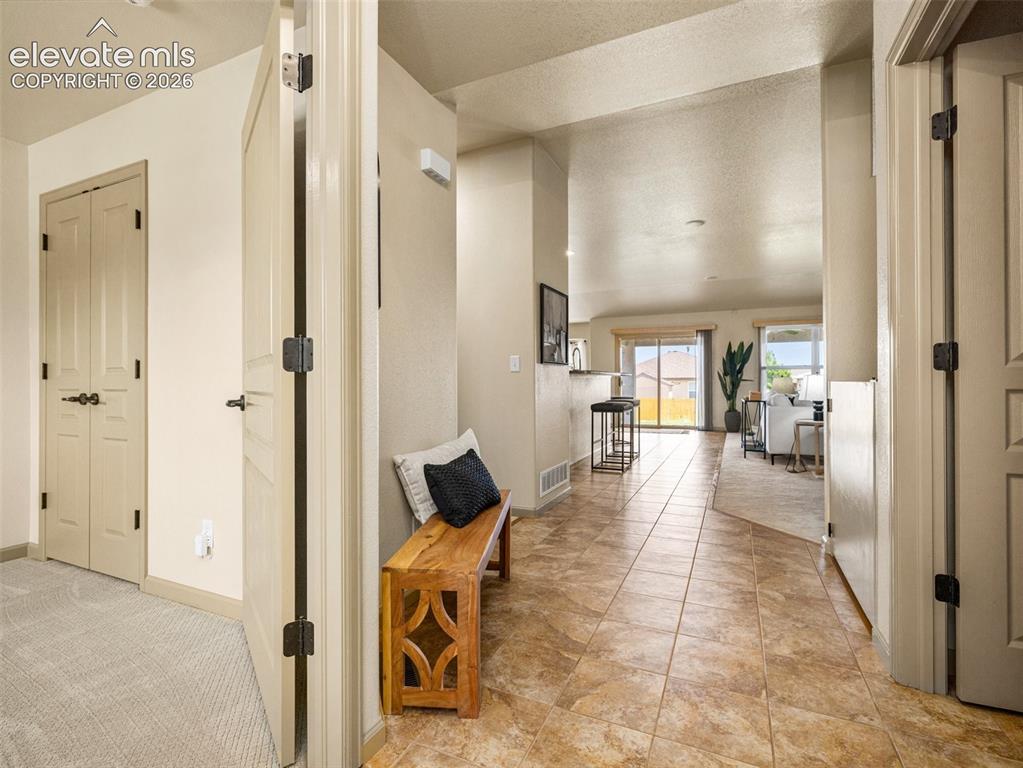 Image 2 of 50: View from front door.  Room to left is the office/5th bedroom. Door to righ
