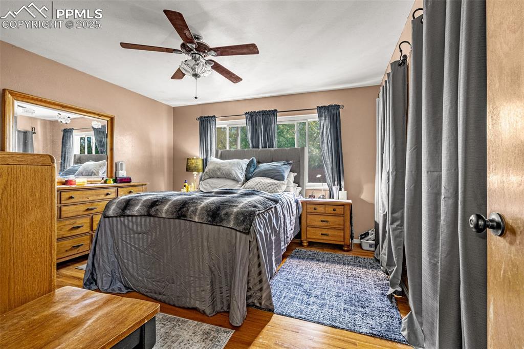 Image 10 of 25: Bedroom featuring light wood-style floors and ceiling fan