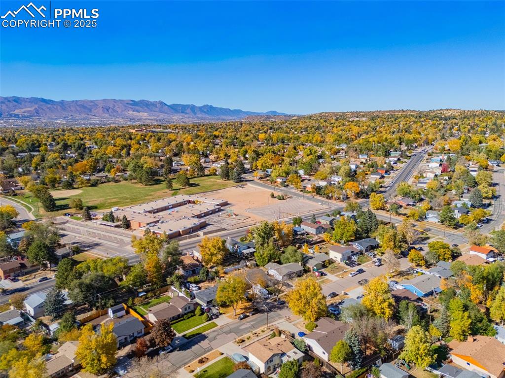 Image 23 of 25: Aerial view of residential area featuring mountains