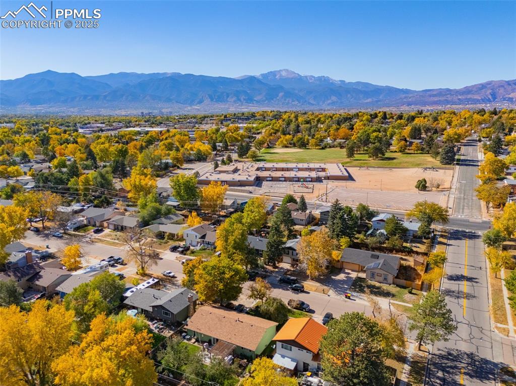 Image 24 of 25: Aerial view of residential area with a mountain backdrop