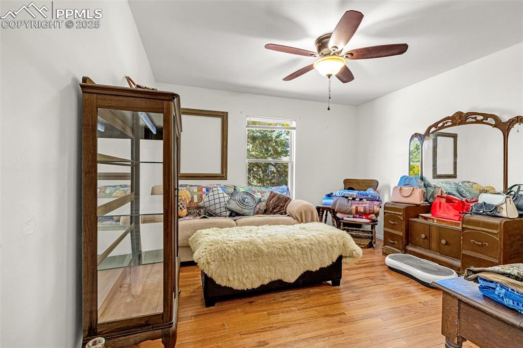 Image 9 of 25: Bedroom featuring light wood-type flooring and a ceiling fan