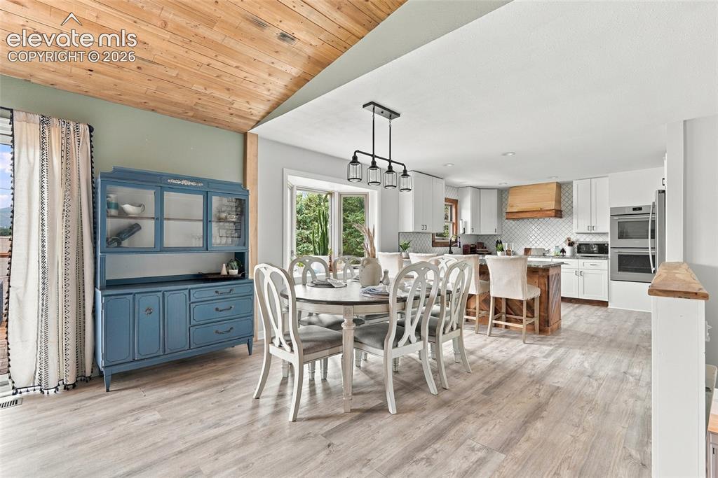 Image 11 of 49: Vaulted wood-paneled ceiling, light wood-finish flooring, recessed lighting