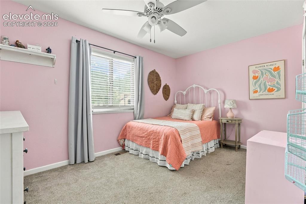 Image 25 of 49: Recessed window with blinds, ceiling fan with integrated lighting, and neut