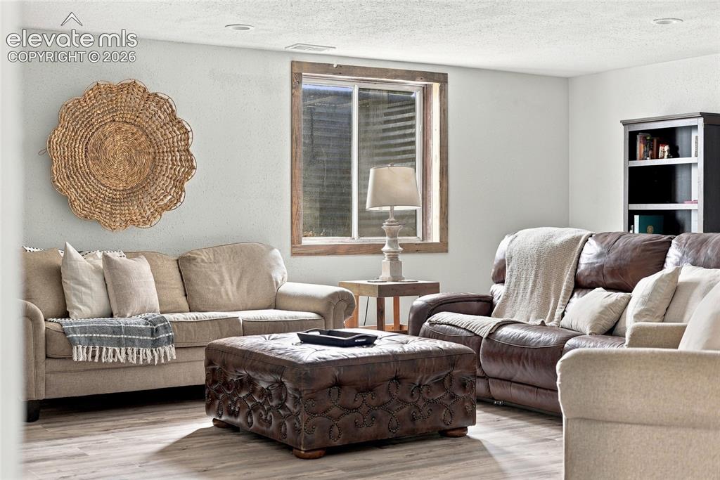 Image 37 of 49: Wood-finish flooring with recessed lighting
