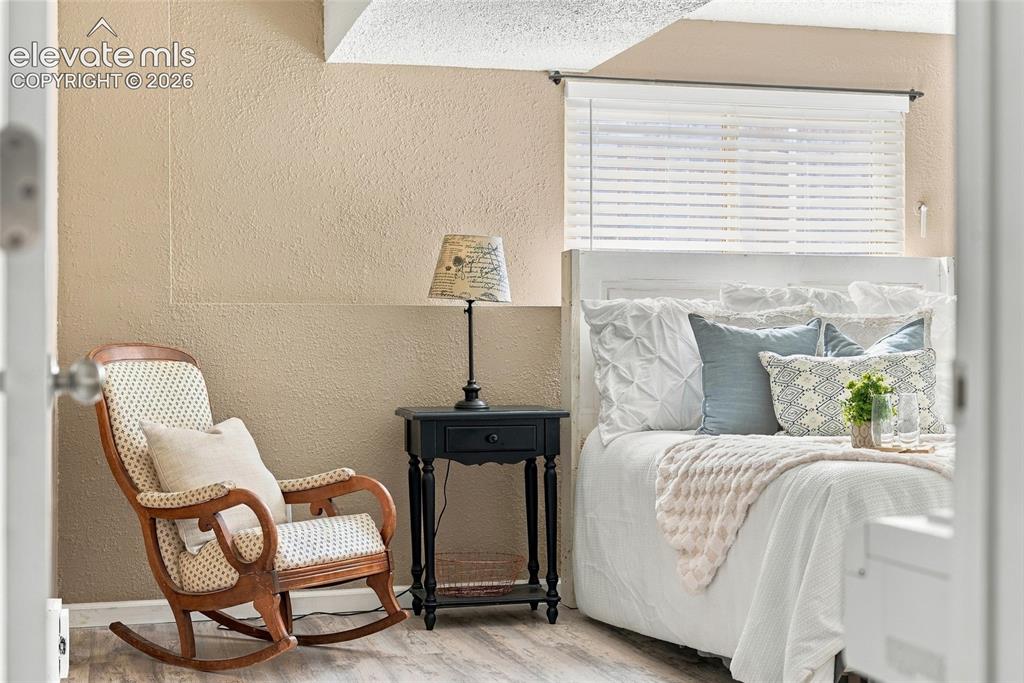 Image 39 of 49: Wood-finish flooring with a textured wall finish