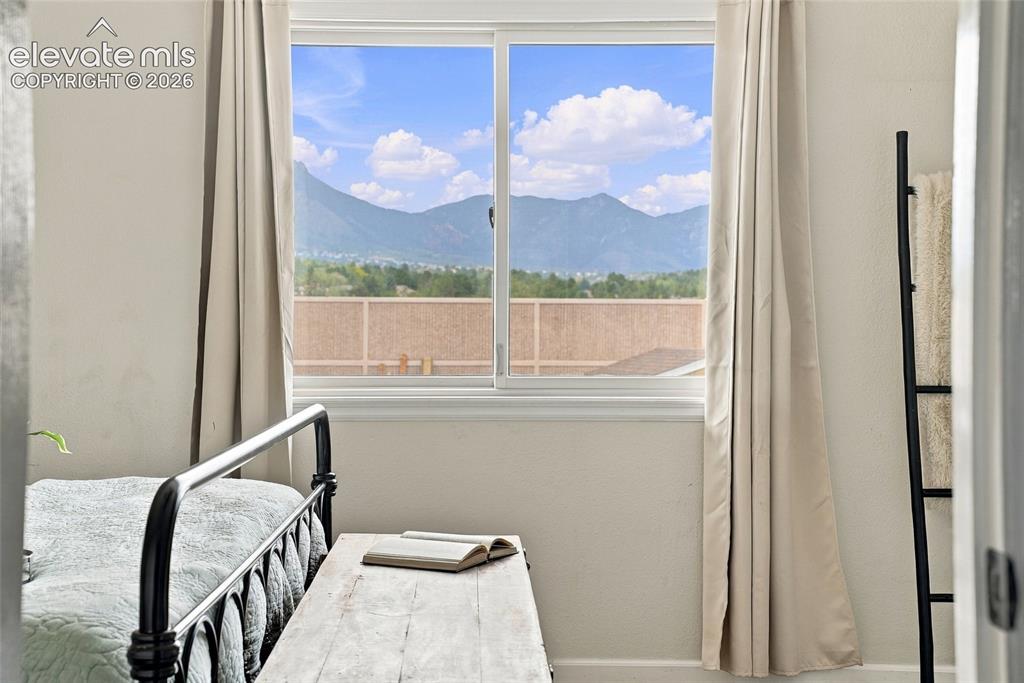 Image 4 of 49: Slider window with mountain scenery and natural light, complemented by a di