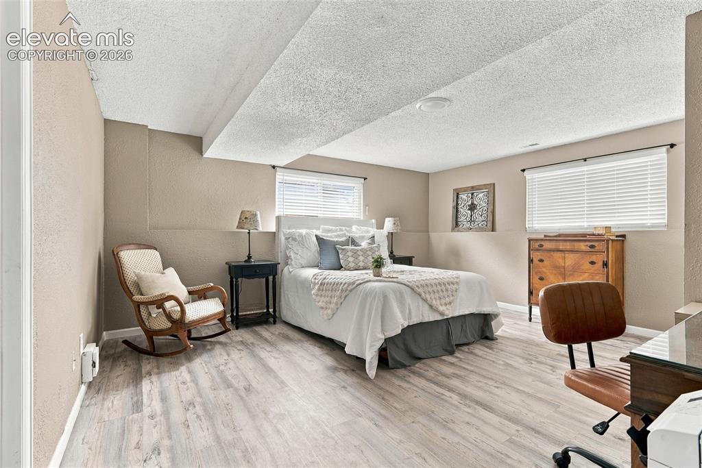 Image 40 of 49: Room featuring light wood-finish flooring, neutral wall tones, and a textur