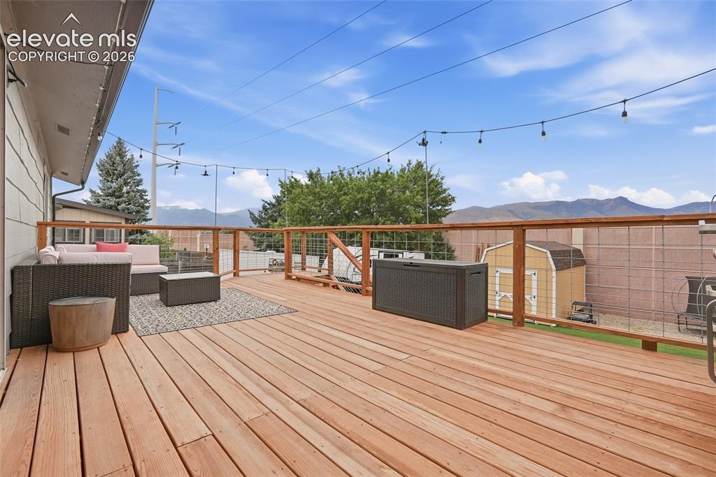 Image 45 of 49: Expansive outdoor deck featuring wood flooring and a wire-mesh railing syst
