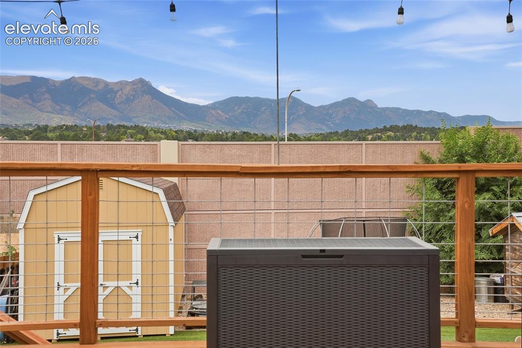 Image 5 of 49: Wooden deck railing with wire infill, offering mountain scenery