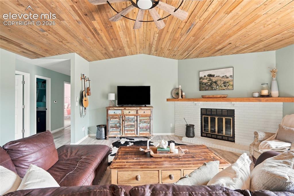 Image 7 of 49: Vaulted wood-paneled ceiling with ceiling fan