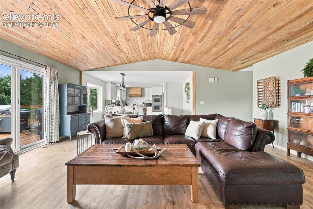 Image 9 of 49: Wood-finish vaulted ceiling with a ceiling fan, light green painted walls,
