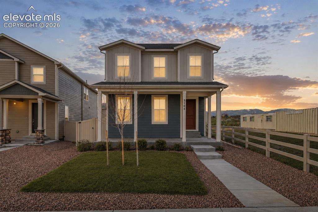 Image 1 of 45: Two-story residence featuring a covered front porch and a distinctive red e