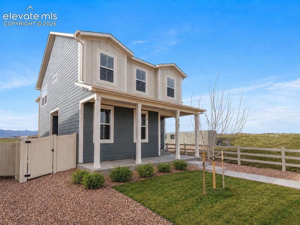 Image 2 of 45: Two-story exterior with horizontal siding and dormer windows