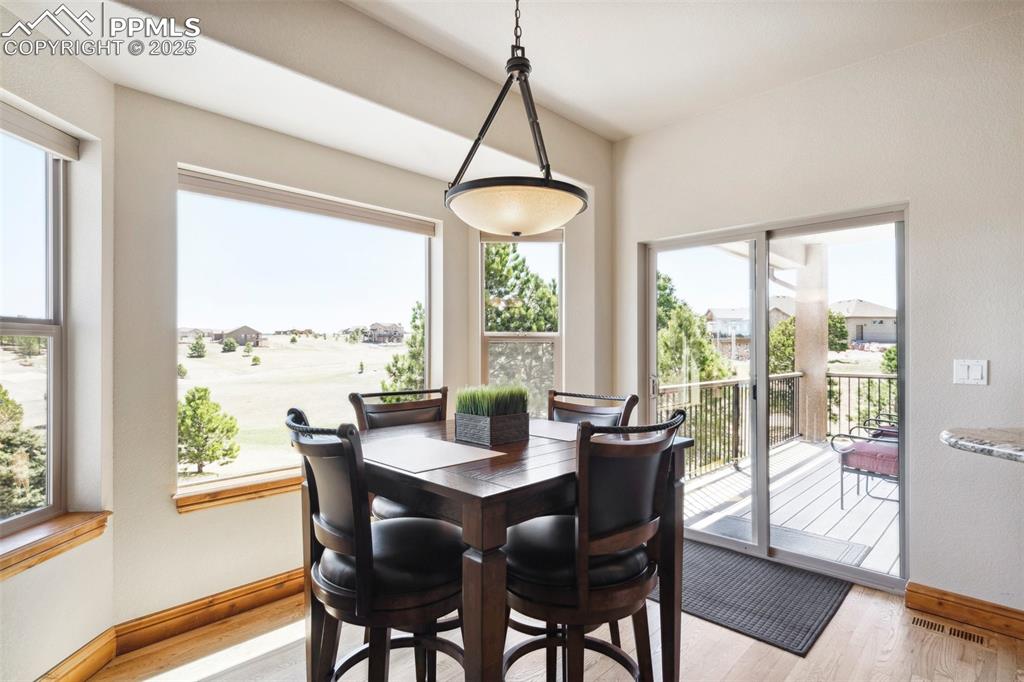 Image 10 of 46: Dining room featuring crown molding, a raised ceiling, arched walkways, and