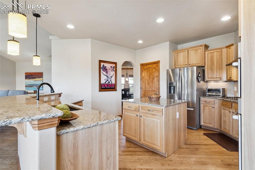Image 15 of 46: Kitchen featuring stainless steel refrigerator with ice dispenser, large is