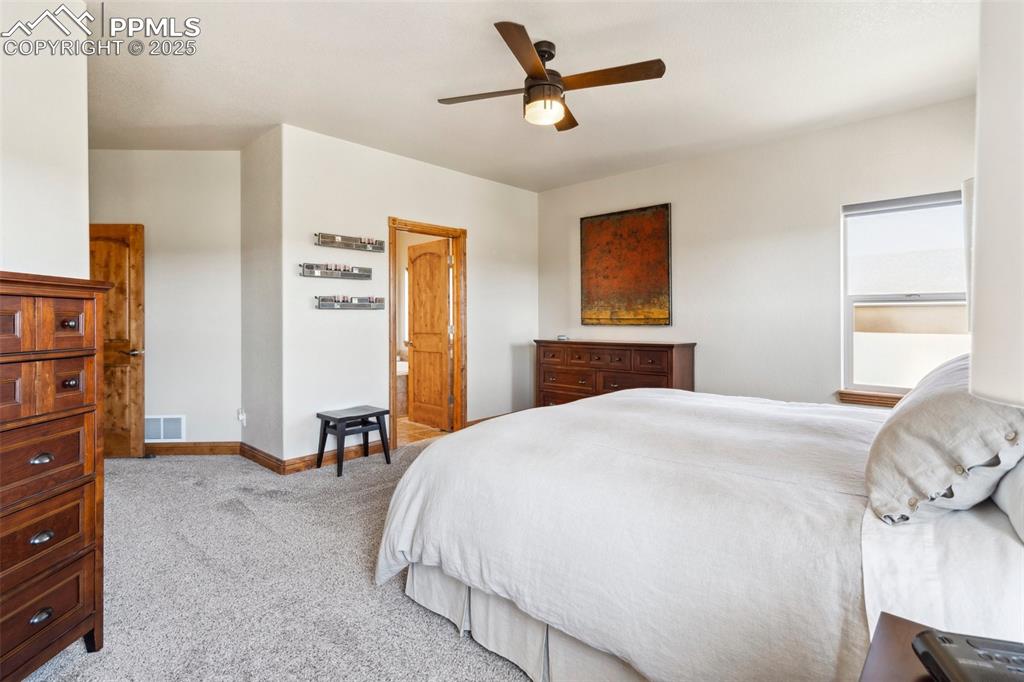 Image 18 of 46: Bedroom featuring carpet flooring, baseboards, a ceiling fan, and visible v
