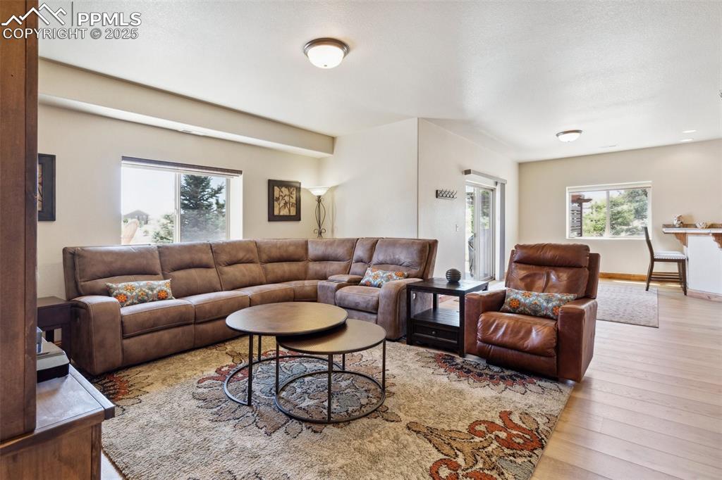 Image 24 of 46: Living area with plenty of natural light and wood finished floors