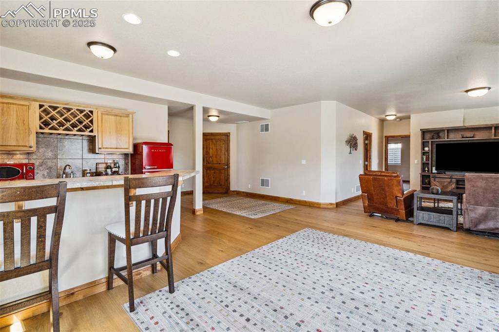 Image 25 of 46: Living area with wood finished floors