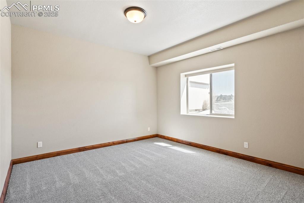 Image 29 of 46: Carpeted spare room featuring baseboards