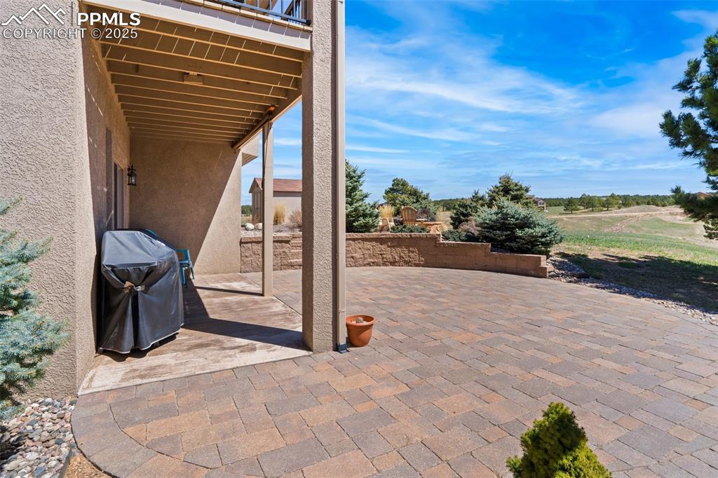 Image 35 of 46: View of patio / terrace with area for grilling and a balcony