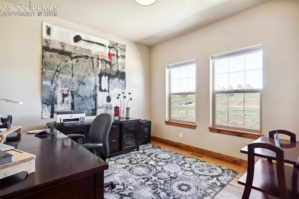 Image 6 of 46: Home office with wood finished floors