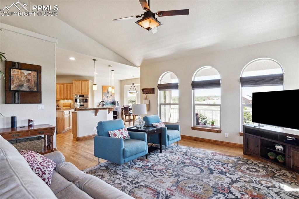 Image 9 of 46: Living room featuring recessed lighting, a ceiling fan, vaulted ceiling, an