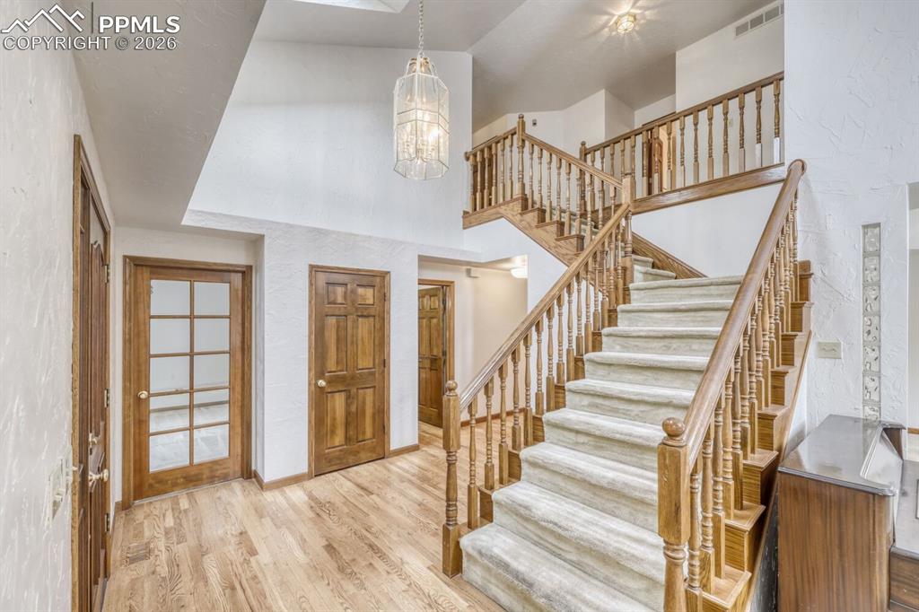 Image 4 of 47: Beautiful entry with hardwoods and coat closet.