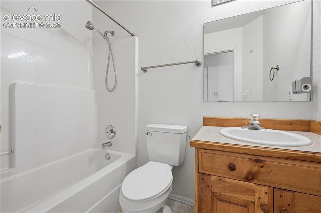 Image 21 of 46: White tub/shower combination with chrome fixtures