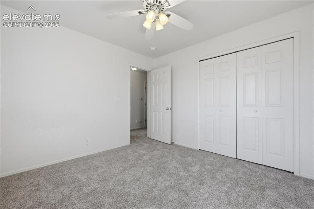 Image 23 of 46: White walls, light gray carpeting, ceiling fan with integrated lighting, an
