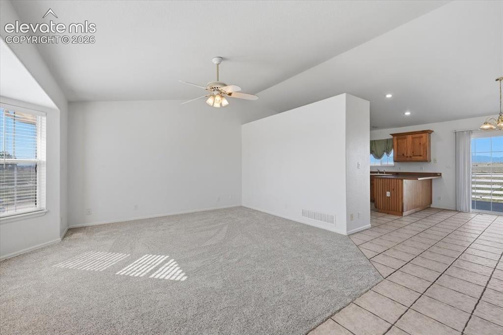 Image 5 of 46: Recessed bay window, ceiling fan, carpet flooring, tile flooring, wood-fini