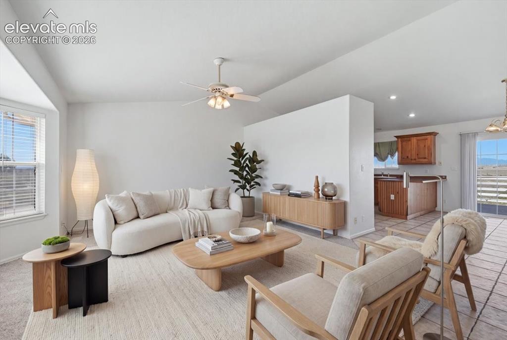 Image 6 of 46: Bright living area featuring a ceiling fan, bay window, and light-colored w