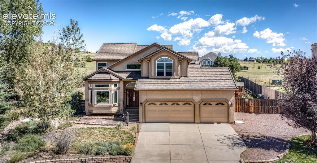 Image 1 of 38: Multi-level residence featuring a stucco exterior, front-facing bay window,