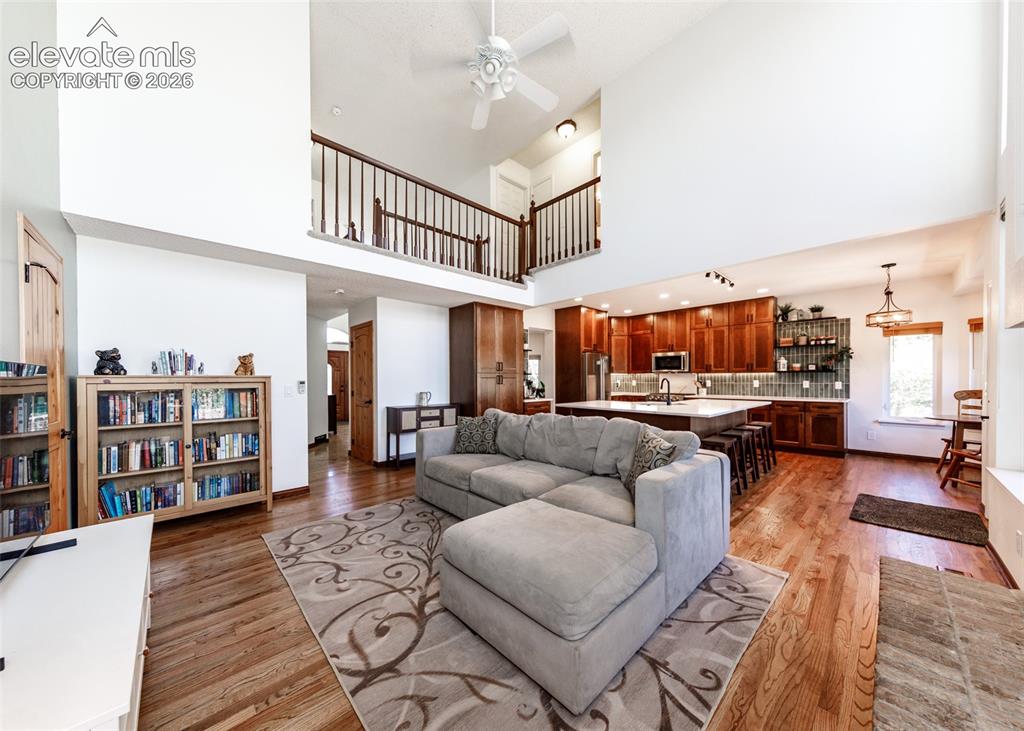 Image 16 of 38: Vaulted ceilings, wood-finish flooring, open-concept living area, kitchen i