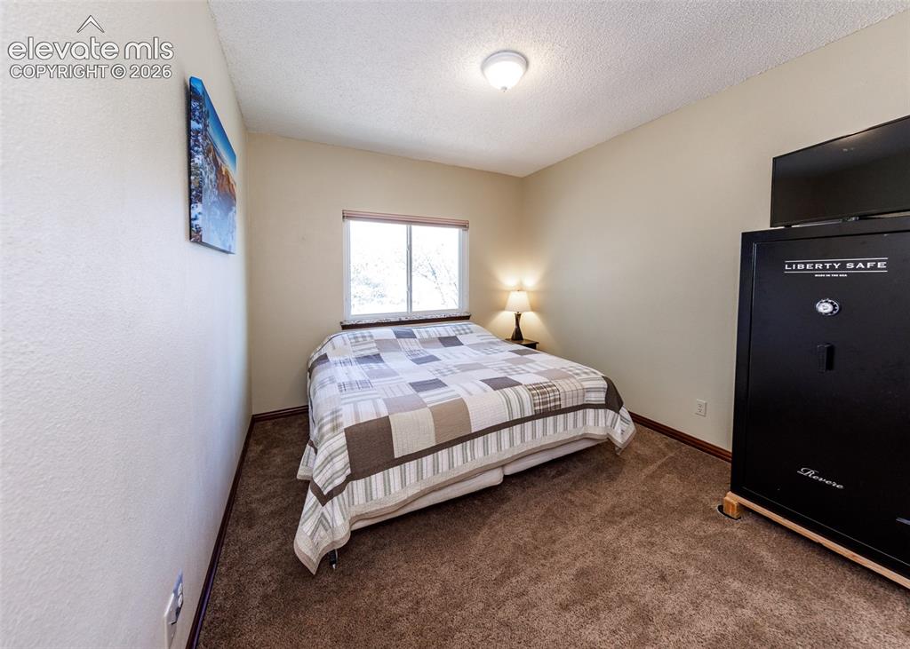 Image 18 of 38: Carpeted flooring, neutral wall tones, and a window with natural light