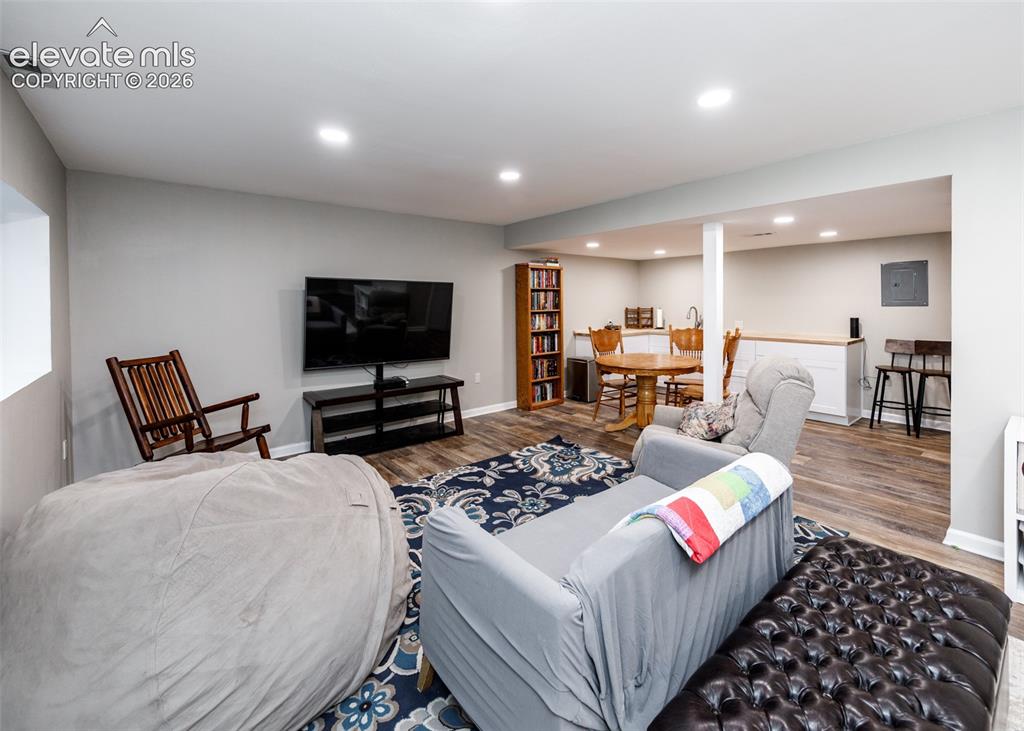 Image 31 of 38: Spacious recreational area featuring wood-finish flooring, recessed lightin