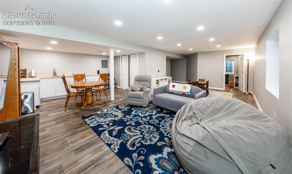 Image 32 of 38: Spacious finished basement with wood-finish flooring, recessed lighting, an
