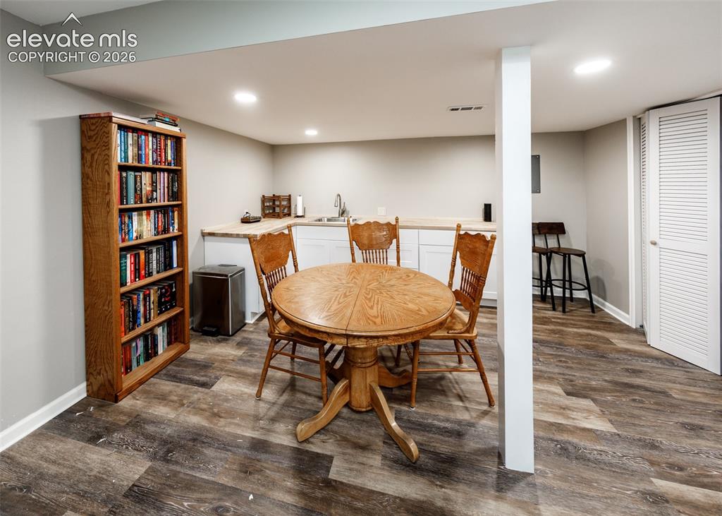 Image 33 of 38: Recessed lighting illuminates the space, featuring wood-finish flooring, wh