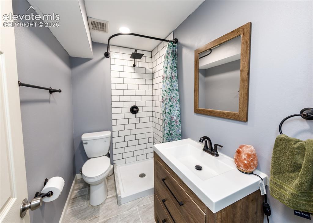Image 36 of 38: Modern bathroom featuring white subway tile shower surround with oil-rubbed