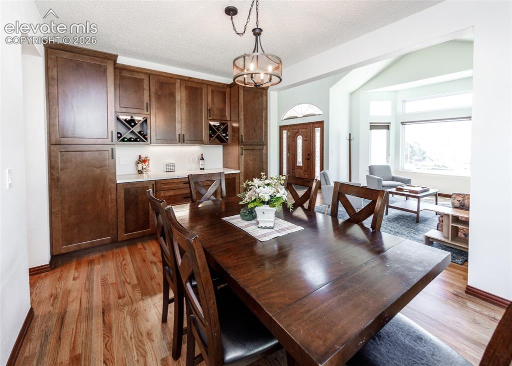 Image 9 of 38: Hardwood flooring throughout, built-in cabinetry with wine storage, recesse