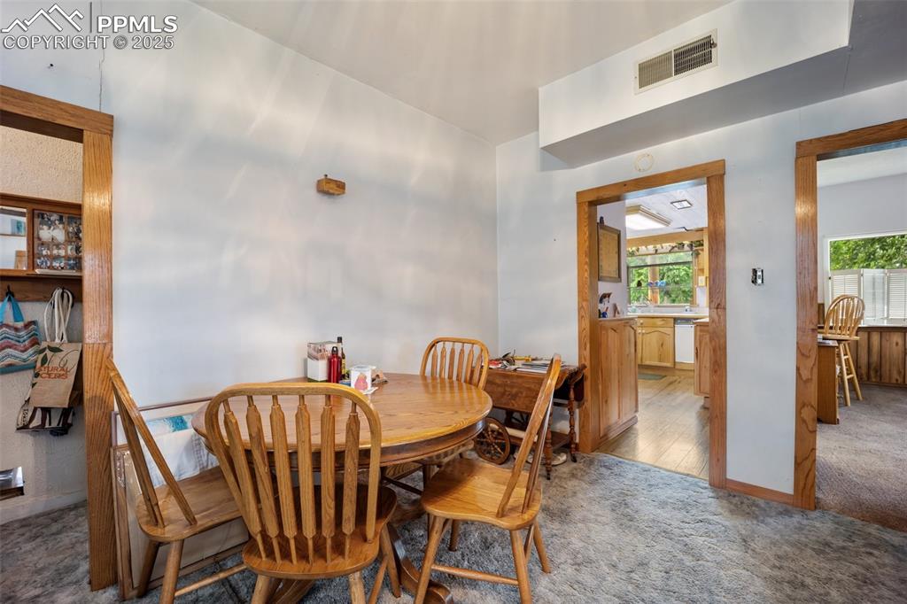 Image 23 of 48: Carpeted dining area with healthy amount of natural light