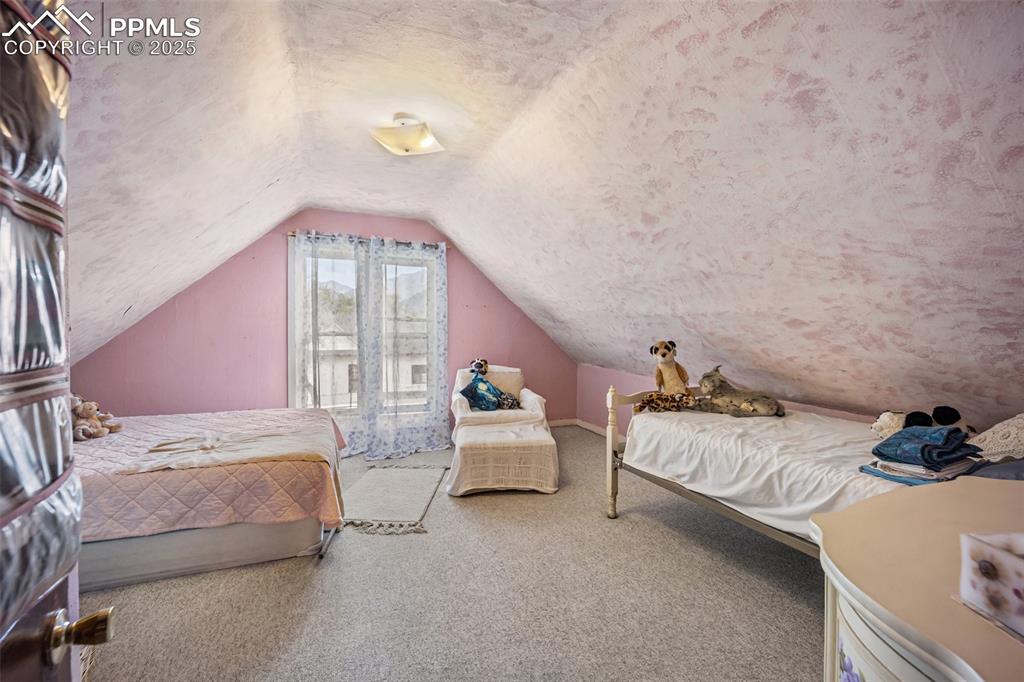 Image 30 of 48: Bedroom with carpet and vaulted ceiling