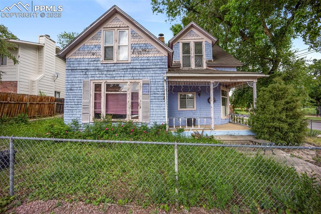 Image 32 of 48: Victorian house featuring a porch and a shingled roof