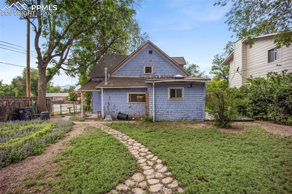Image 4 of 48: Back of house featuring roof with shingles