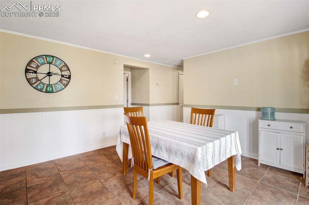 Image 14 of 38: Walk out deck off dining room with hot tub going into dog run/fenced yard