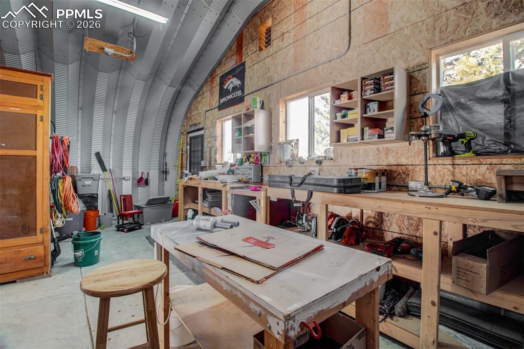 Image 30 of 38: 2 car garage with workshop in back