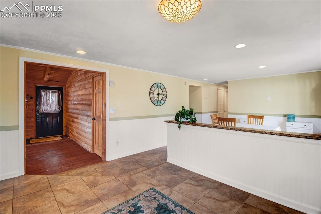 Image 5 of 38: Living room with wood burning stove, wood accents all around along with woo