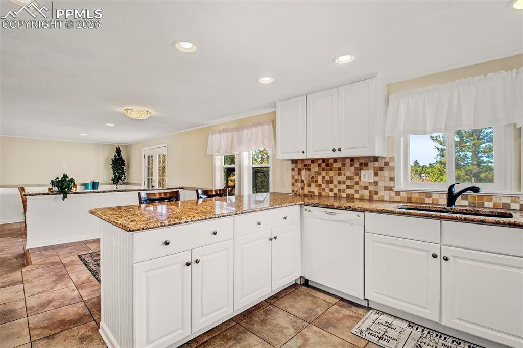 Image 7 of 38: Breakfast area looking at the breakfast bar and kitchen