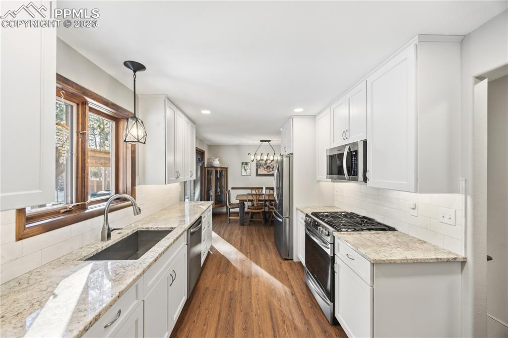 Image 11 of 40: kitchen window overlooks the backyard