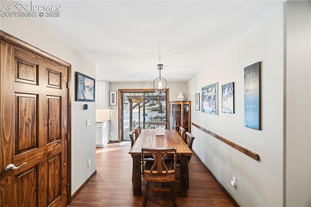 Image 12 of 40: Coat closet to the left and dining room overlooking the backyard