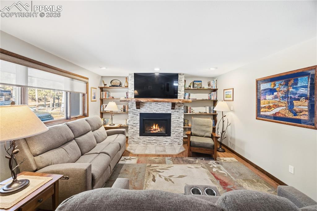 Image 8 of 40: custom made black walnut mantel and built-in shelving